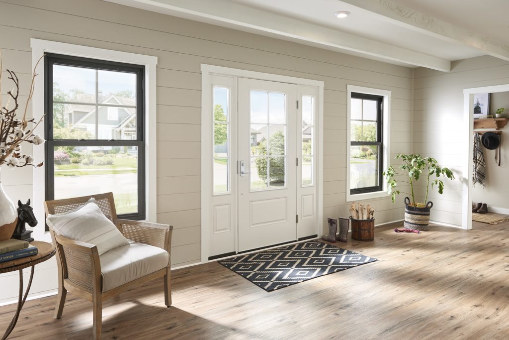 White front entry door and black, double-hung windows
